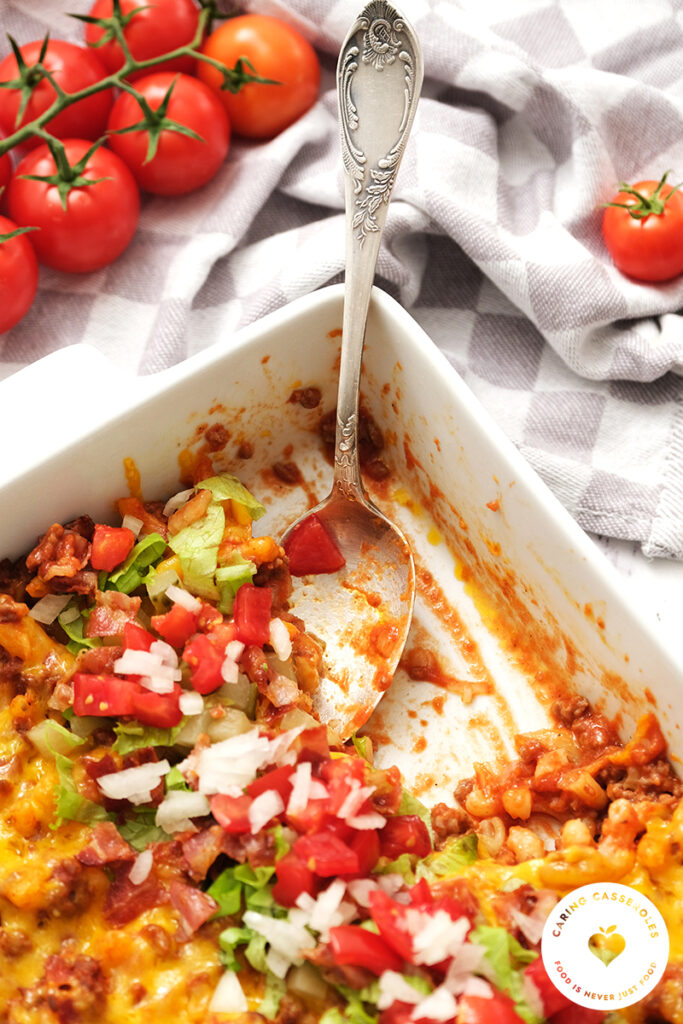 cheeseburger casserole in serving dish with a serving removed