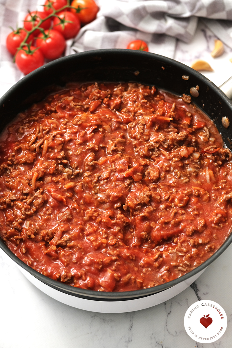 browned hamburger, sauce and spices in skillet