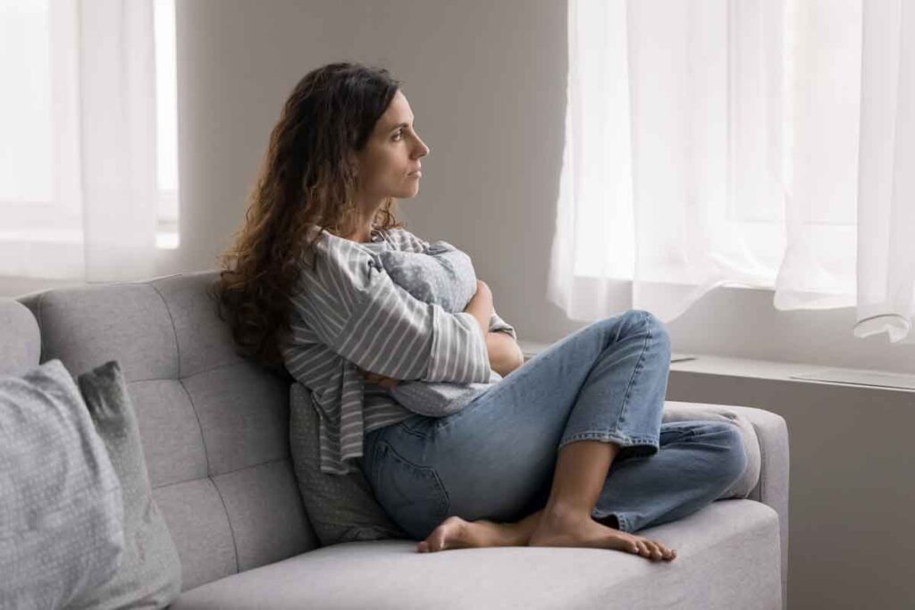 lonely woman sitting on couch