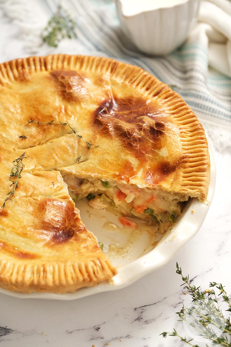 chicken pot pie in pie plate with one slice removed