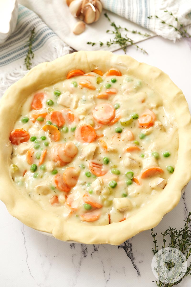 The pie filling and sauce placed into the pie crust.