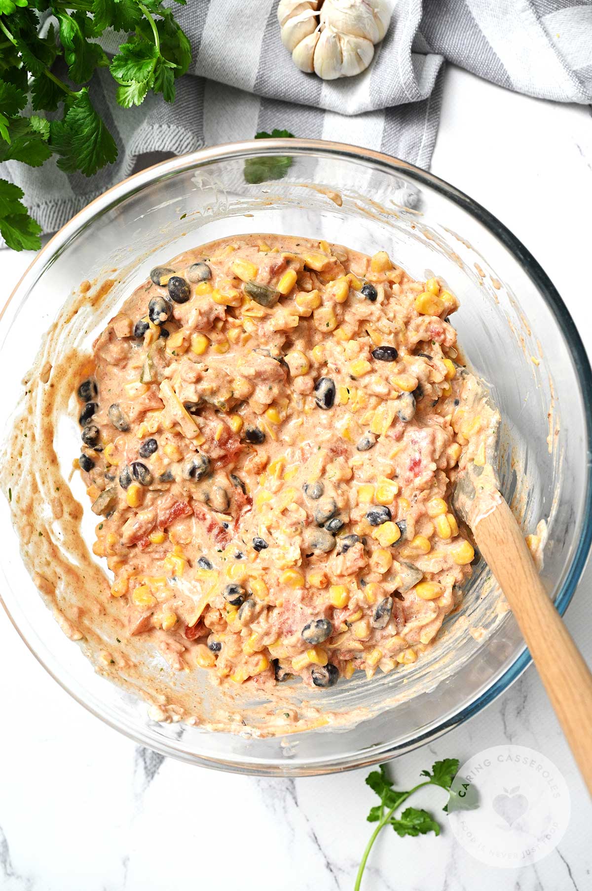 Cooked rice, black beans, corn, diced tomatoes, salsa, sour cream, 1 cup cheese and spices combined in a bowl.