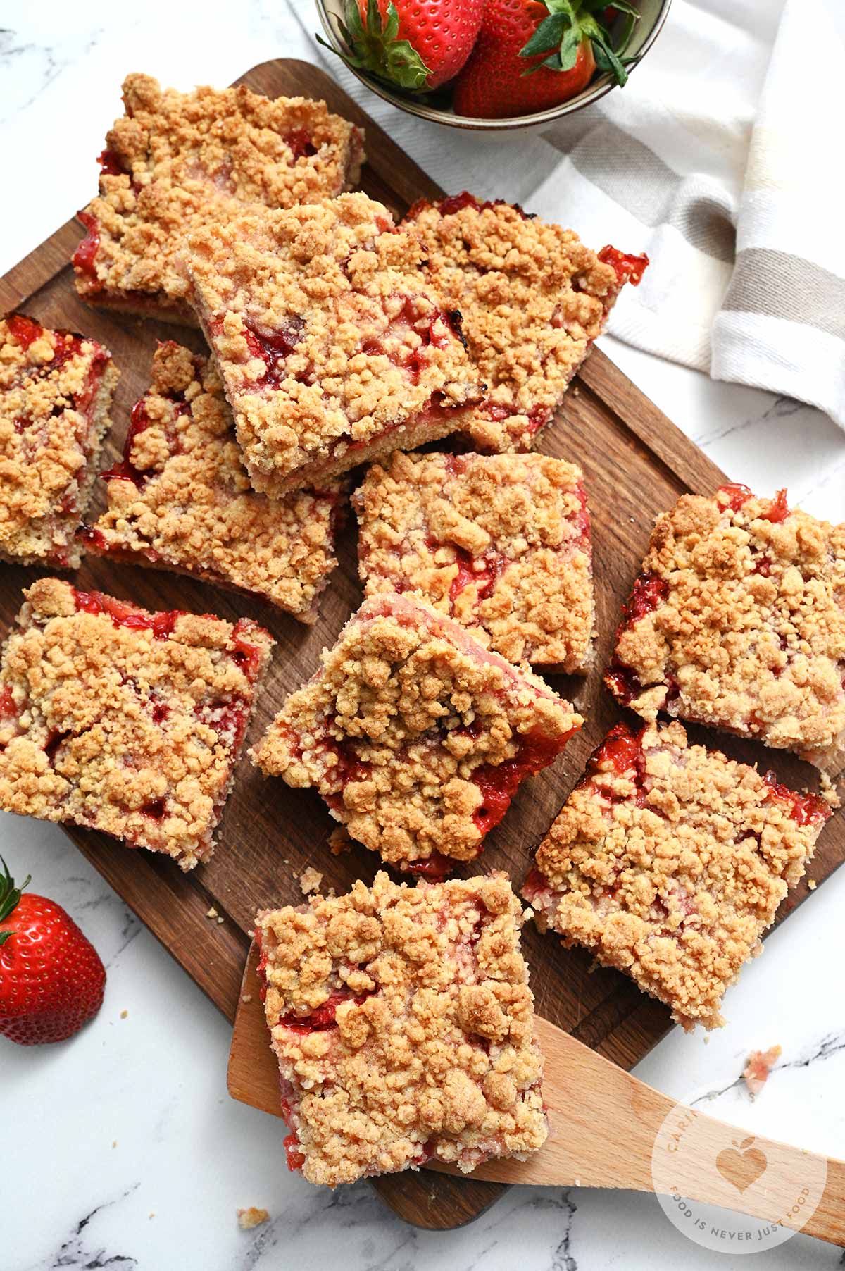 Strawberry crumb bars cut into squares after they have cooled. 