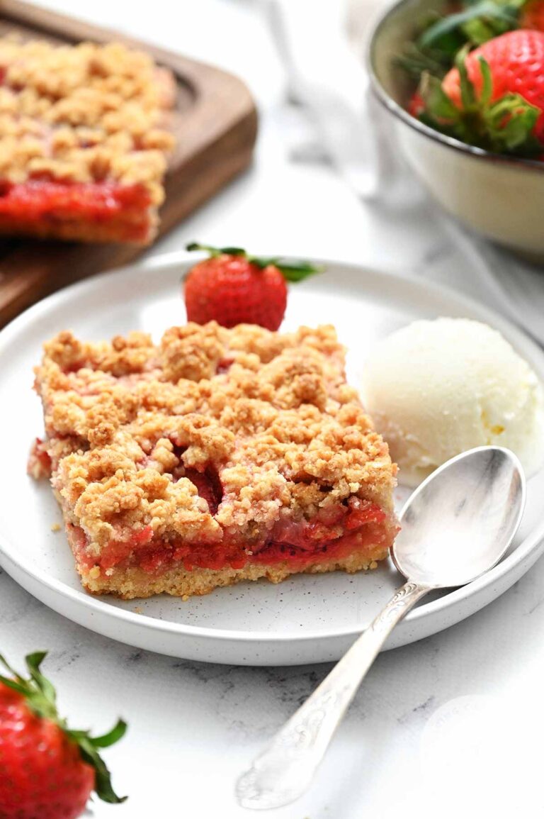 strawberry crumb bar on white plate with fork