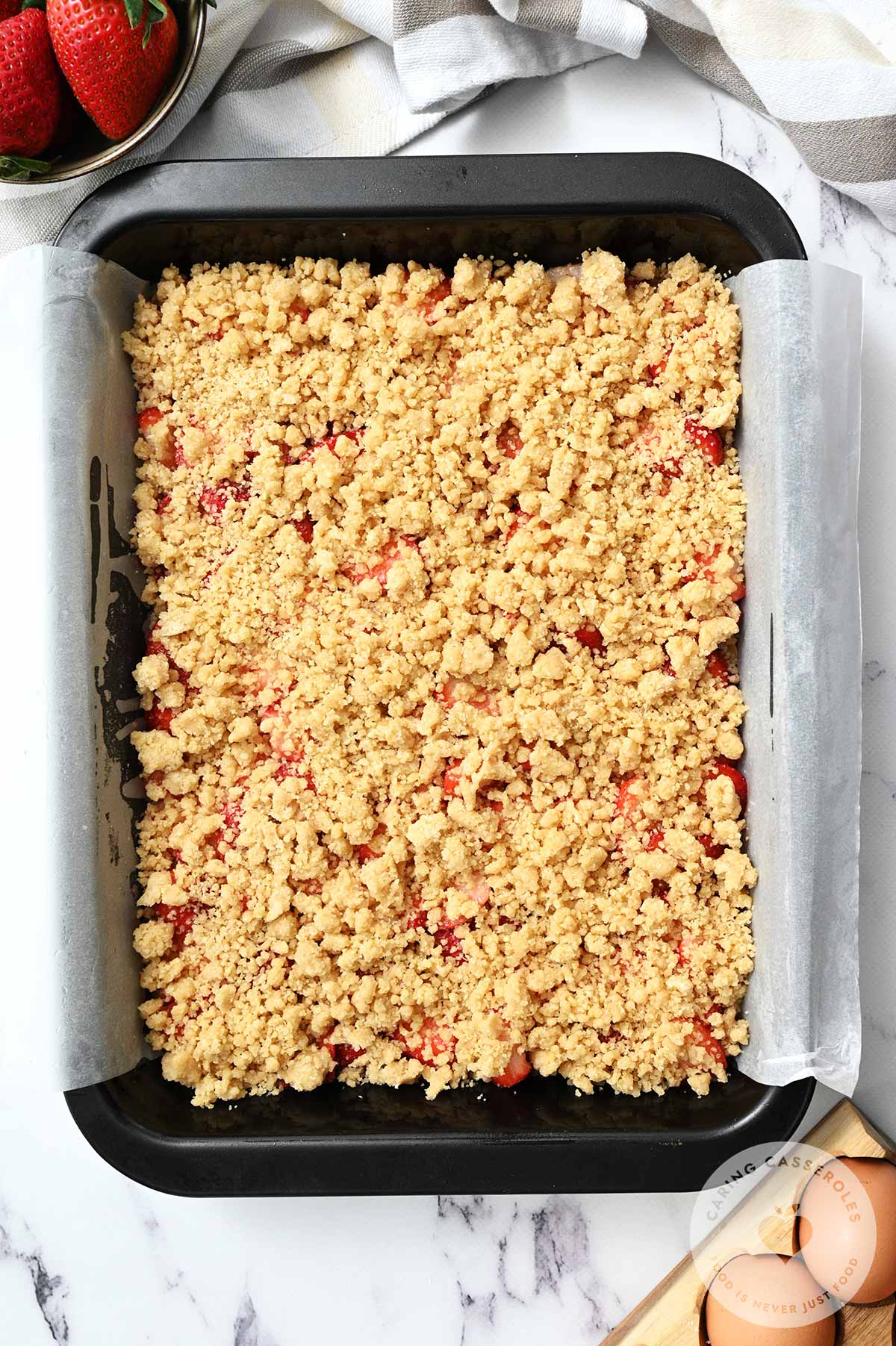The strawberry mixture spread in the baking dish and topped with the rest of the crumb mixture.