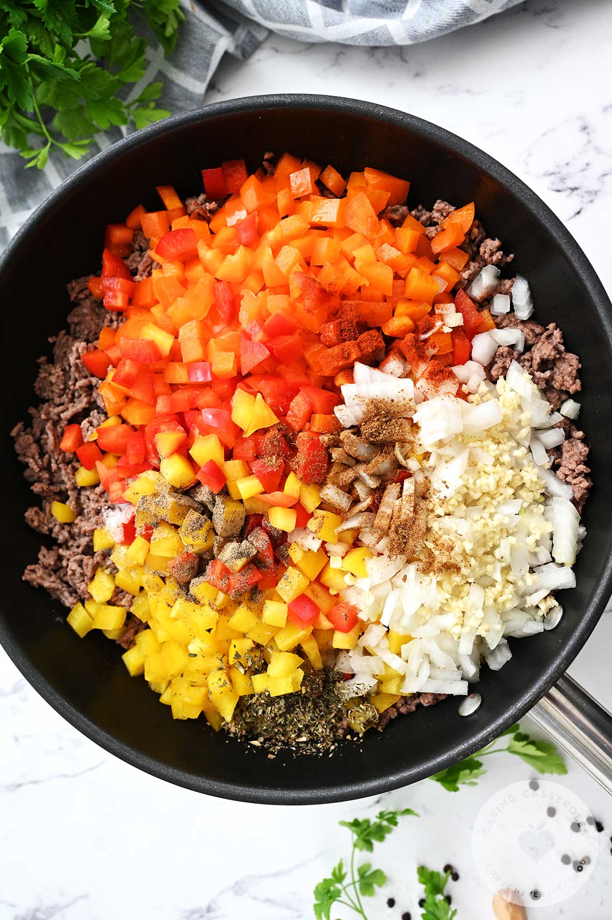 Diced bell peppers, onion, garlic, spices, salt, and pepper added to the skillet and cooked until the veggies soften.  