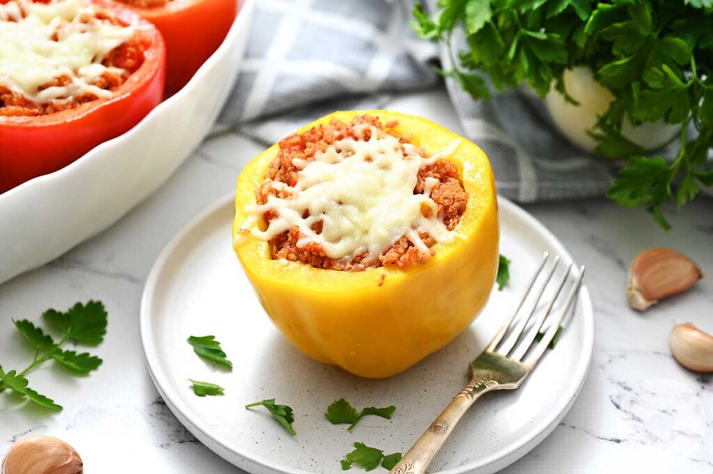 A ground turkey stuffed pepper on a plate with a fork.