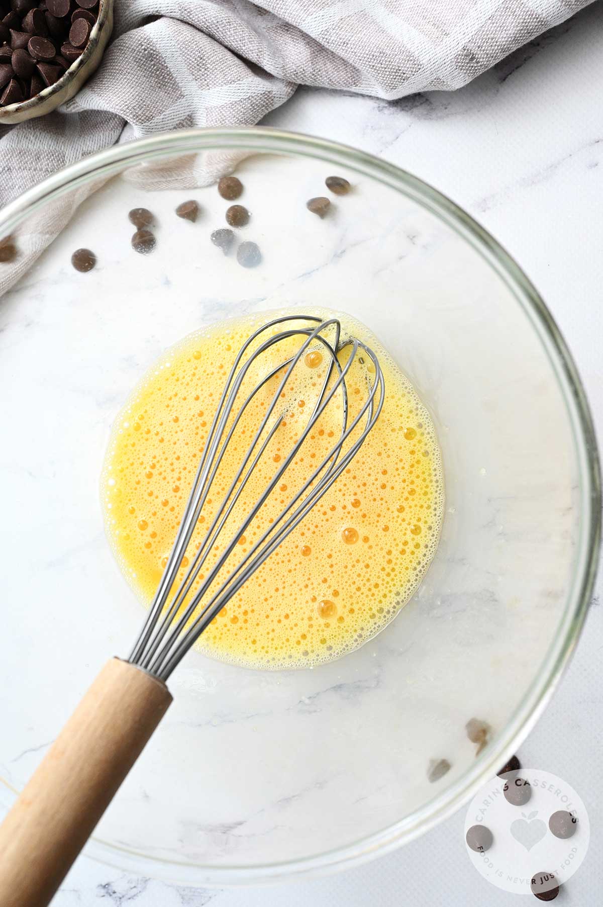 Beaten eggs being whisked in a bowl.