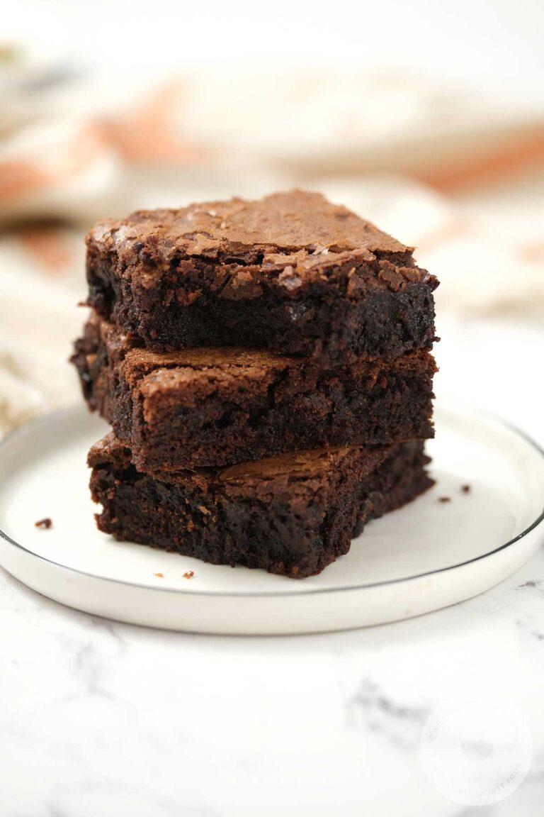 Three stacks of Chocolate Brownies on a white plate.