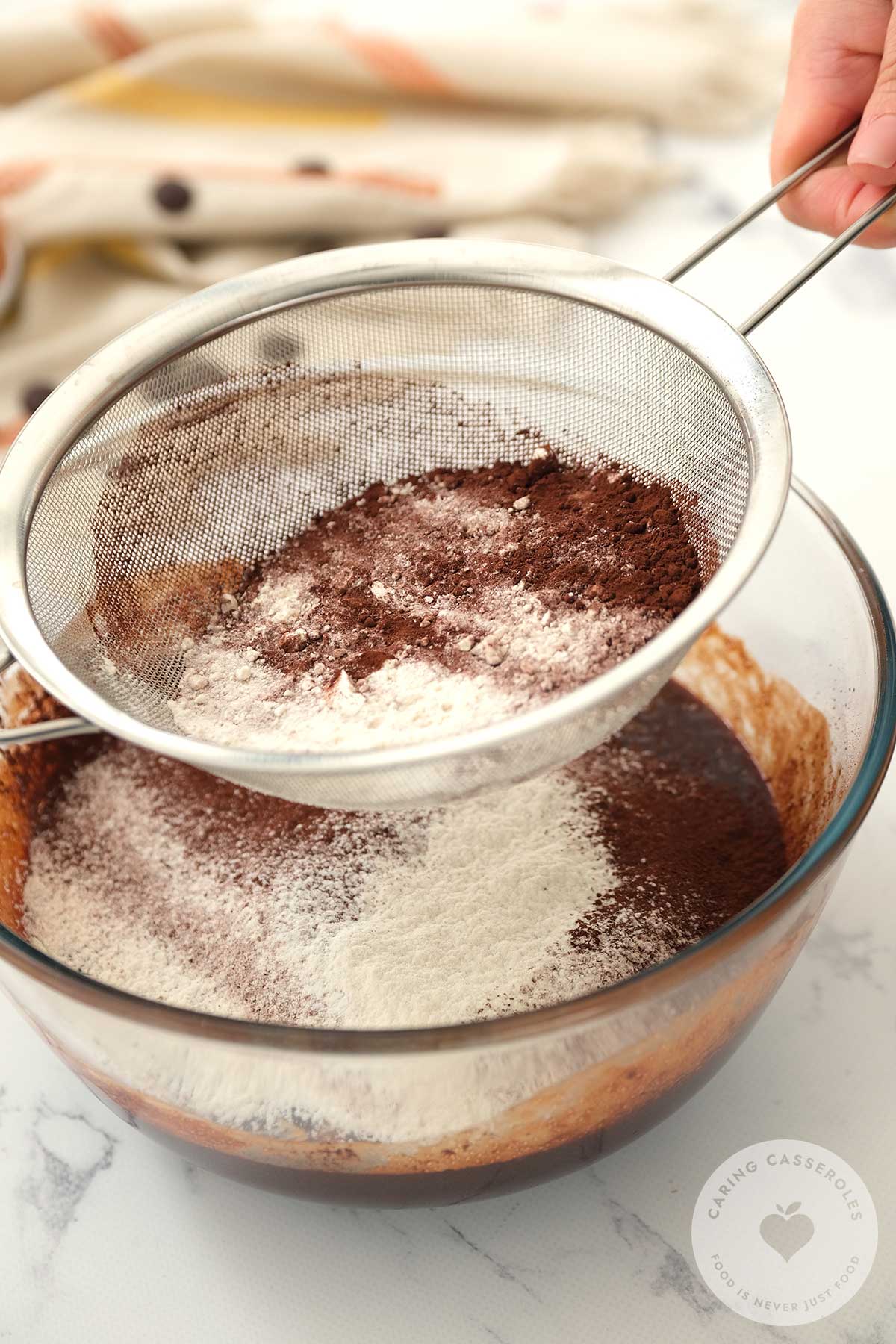 Flour is sifted into the mixture and stirred in thoroughly. 