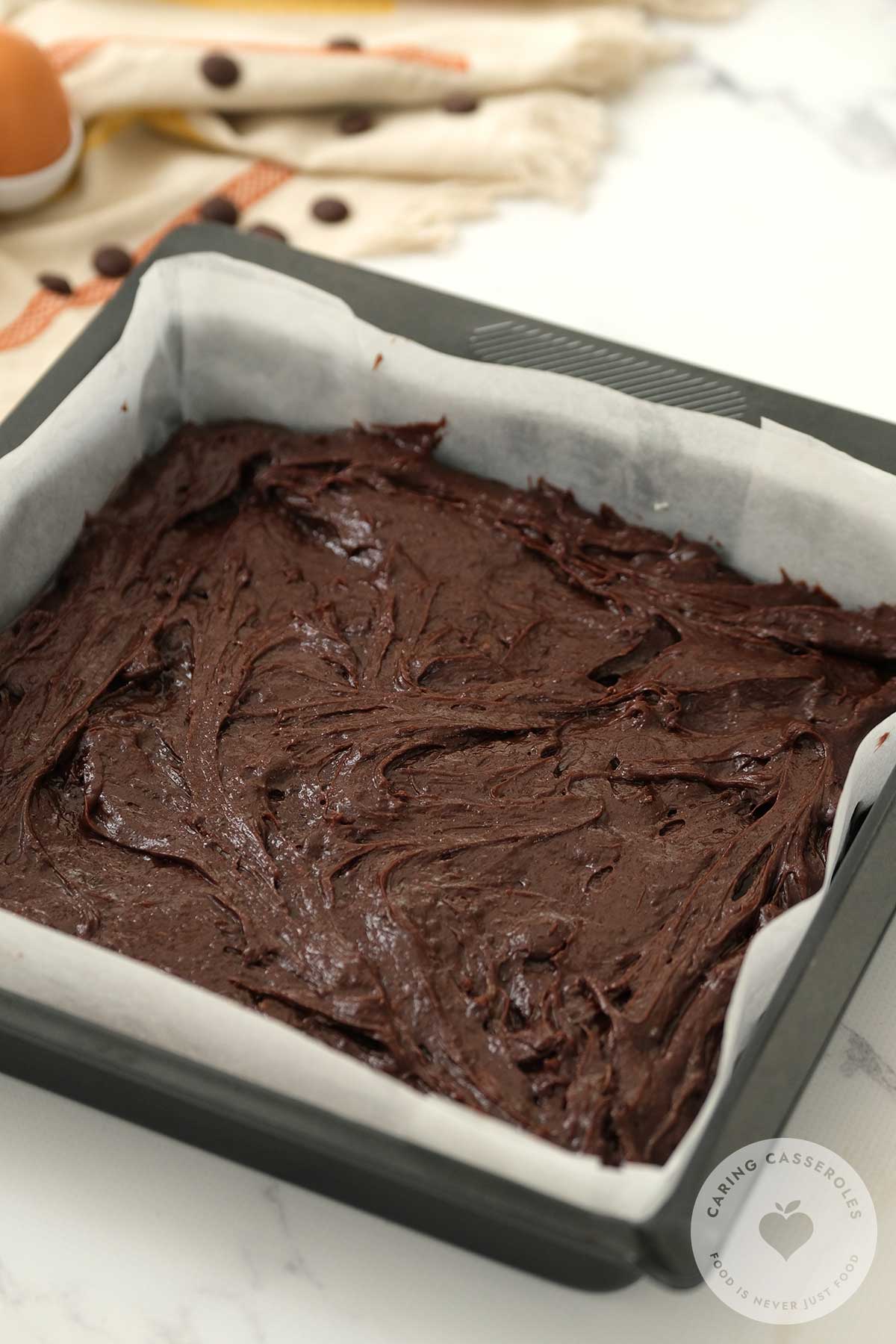 Mixture poured into a baking tray lined with parchment paper. 