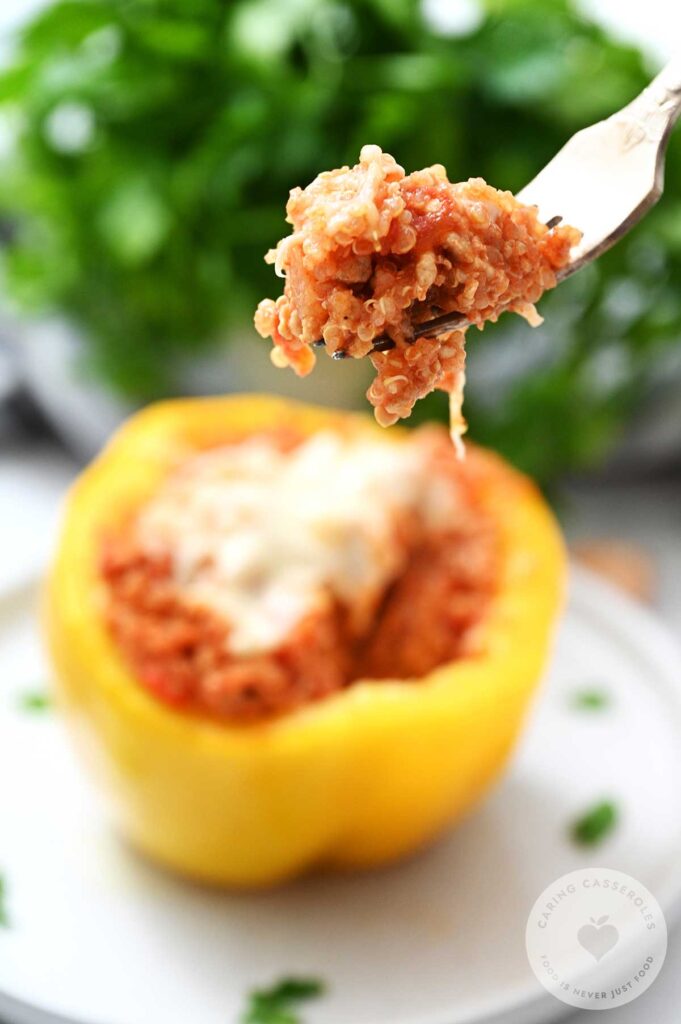 A fork lifting a portion of a turkey stuffed pepper.