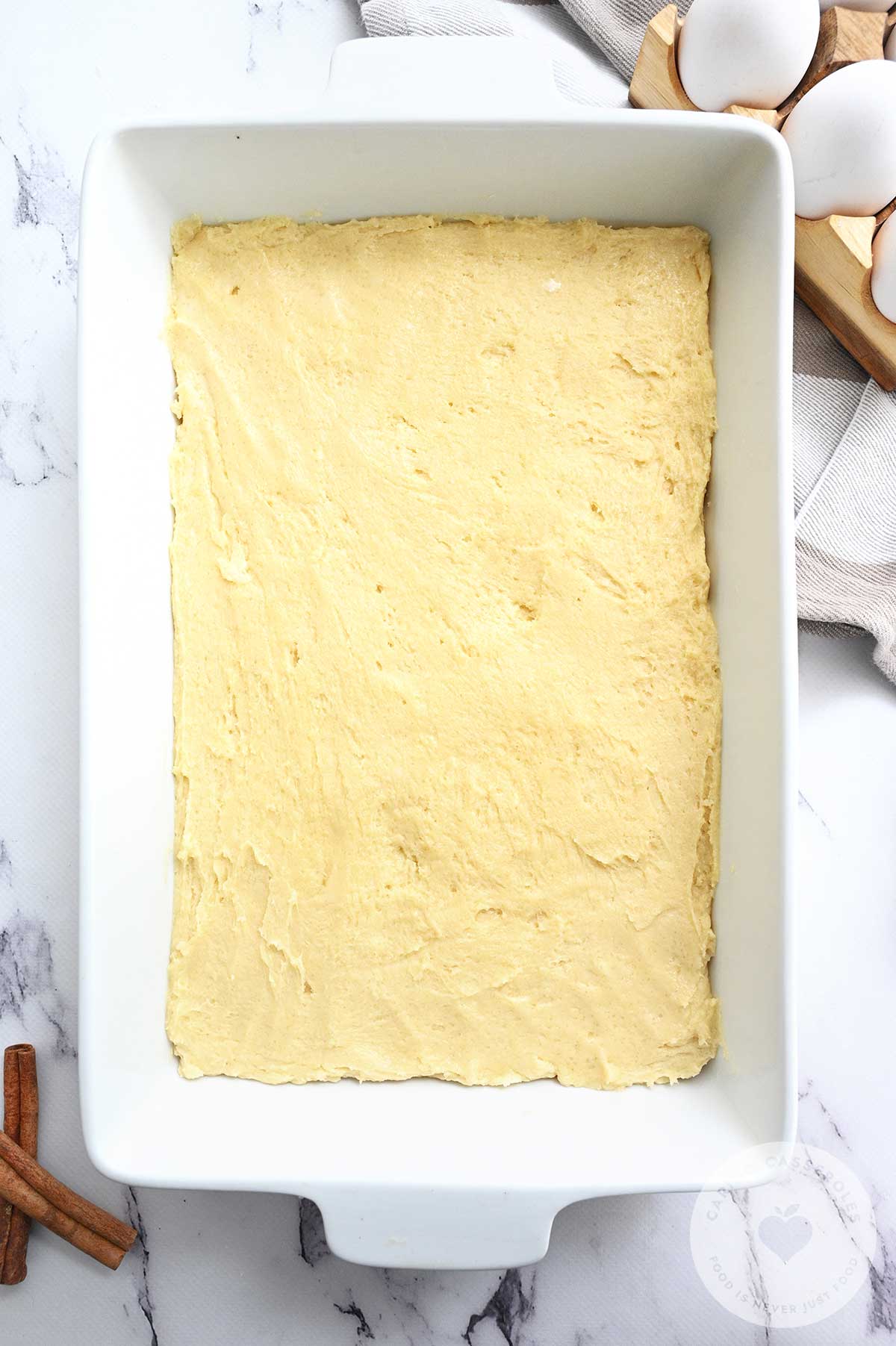 Batter pressed down into a baking tray.