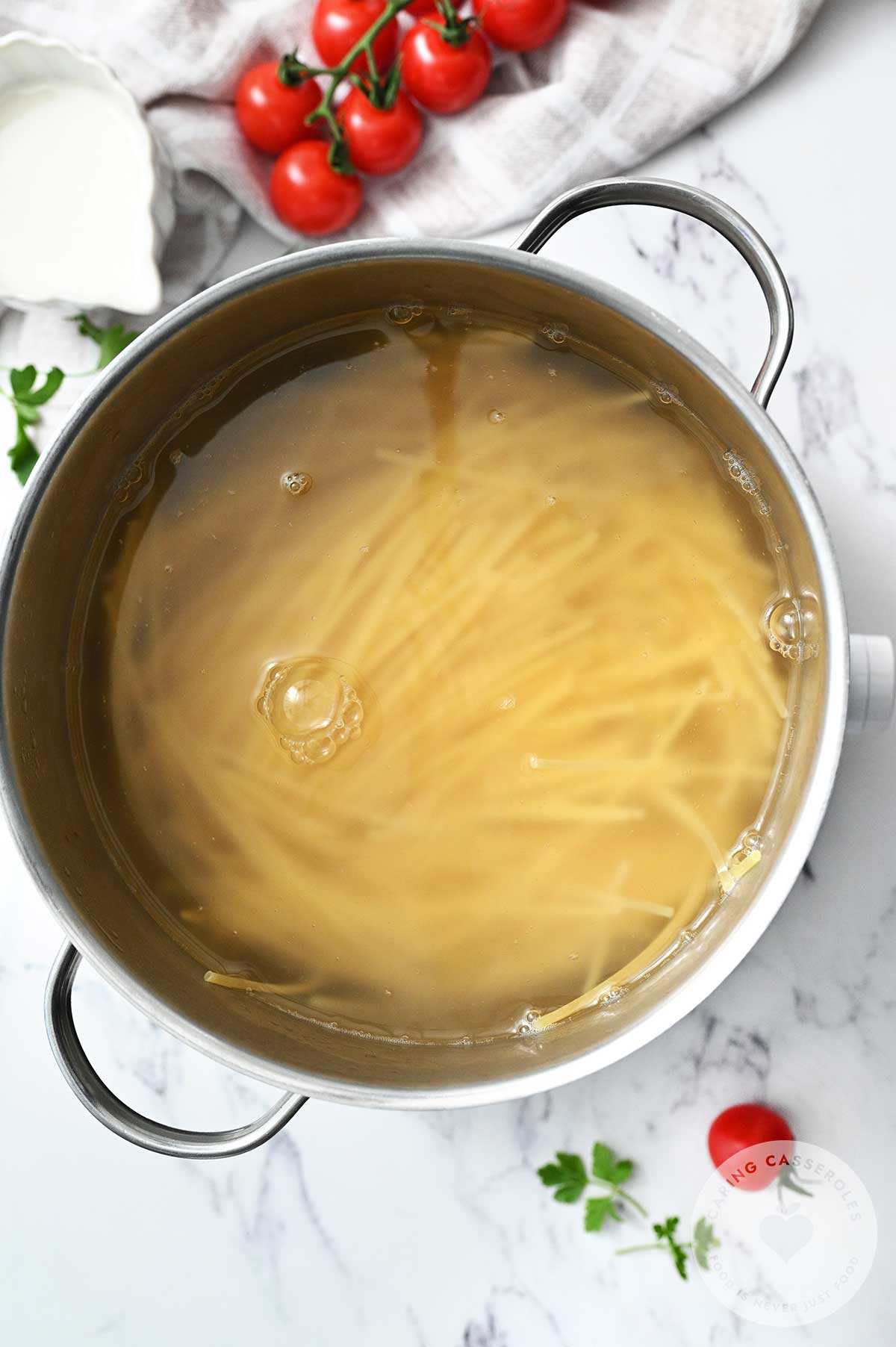 Spaghetti cooking in a pot.