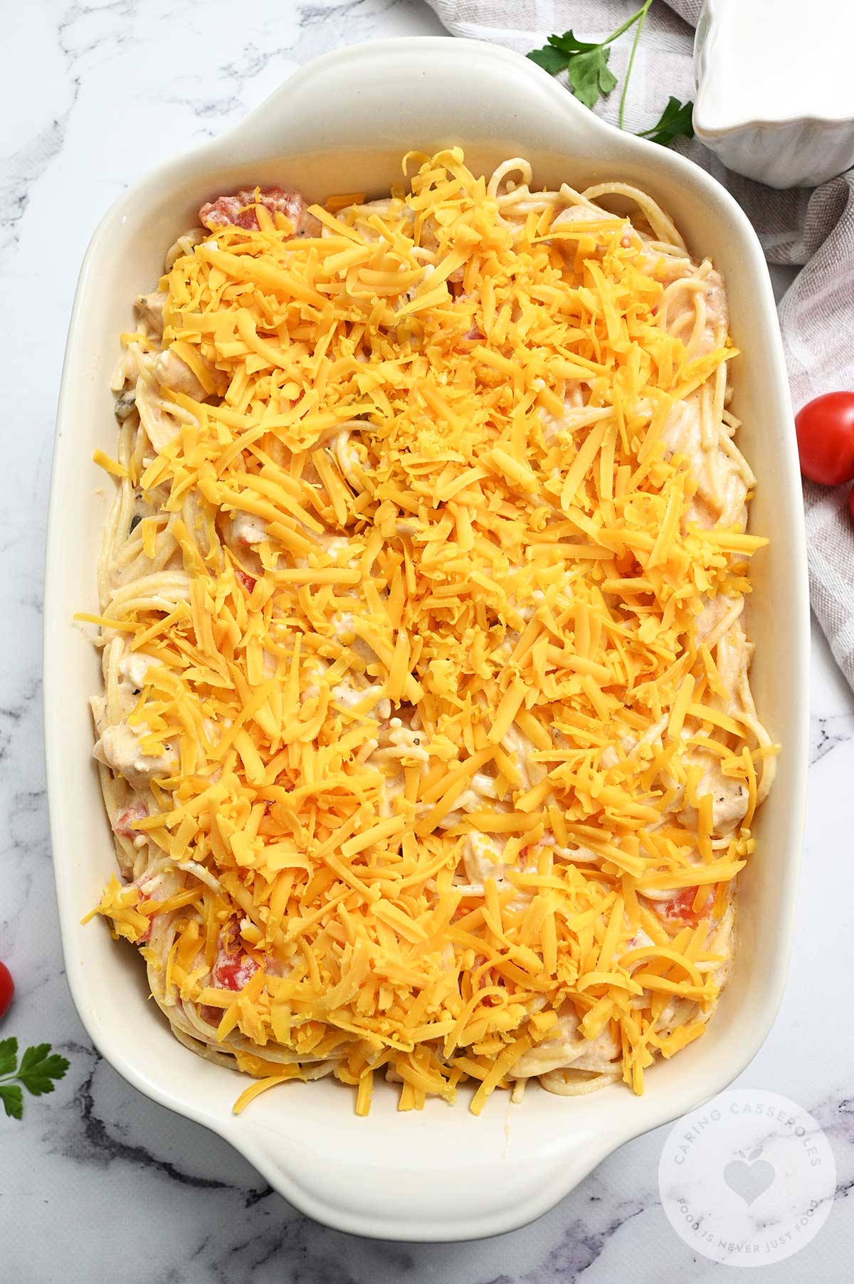 Chicken mixture placed in a baking dish and topped with the remaining cheese.