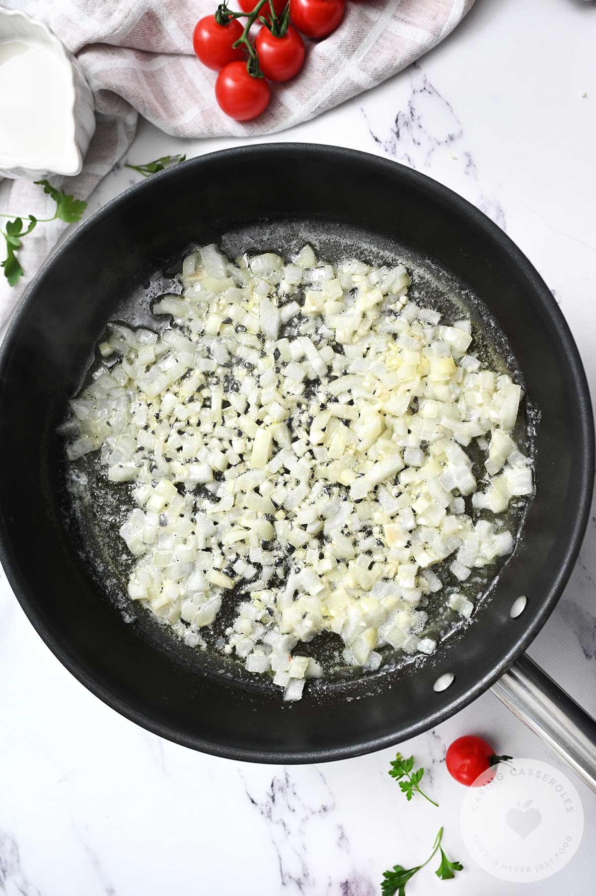 Onion and garlic frying in a pan.