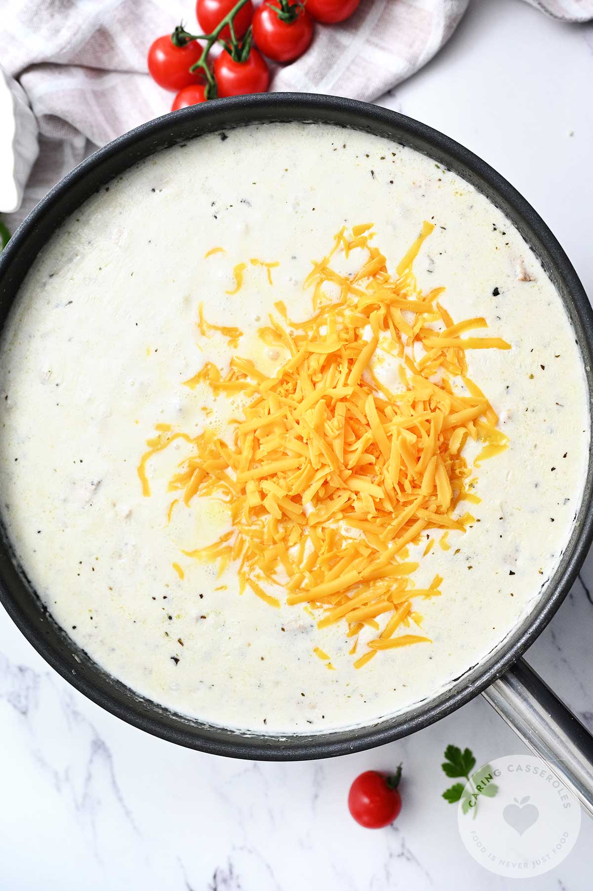 Flour sprinkled over the chicken, with added  broth, cream and cheese added to the onion, garlic and chicken and simmered slowly in the pan. 