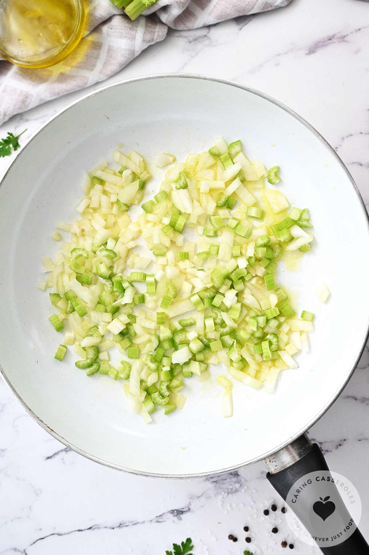Onions and celery browning in a pan in butter.