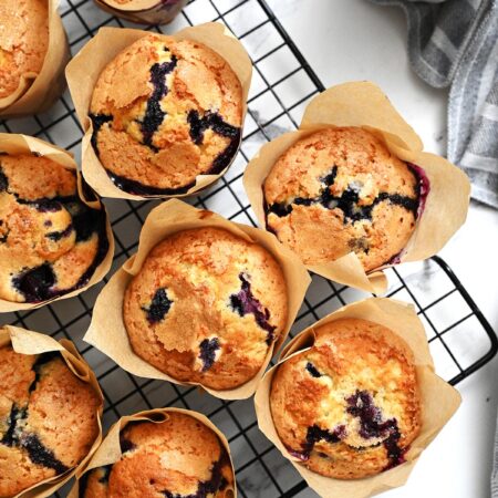 looking down on blueberry muffins on cooling rack