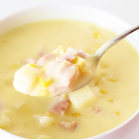 ham corn chowder pantry meal in white bowl with a spoon