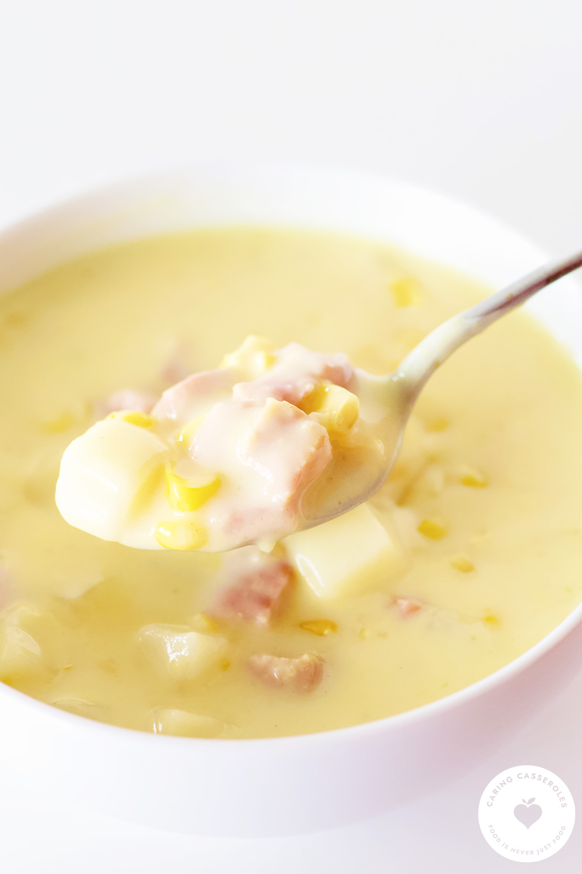 bowl of ham corn chowder in spoon