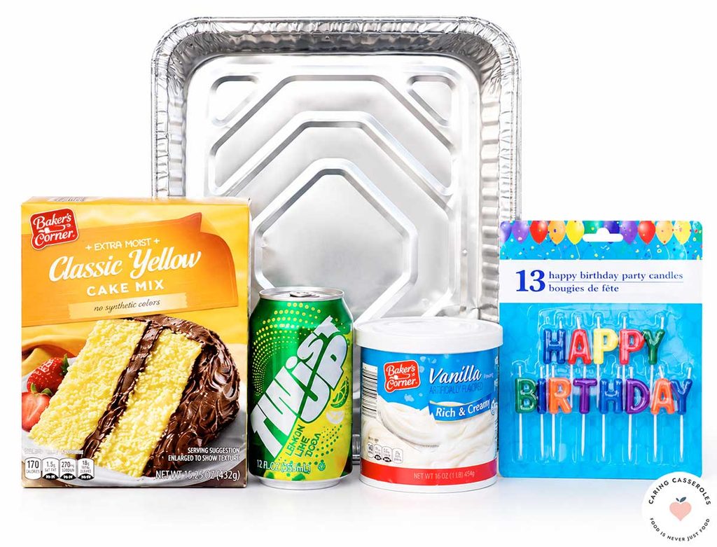 Birthday cake kit supplies including yellow cake mix, a 12-ounce can of lemon-lime soda, vanilla frosting, birthday candles, and a disposable aluminum cake pan.